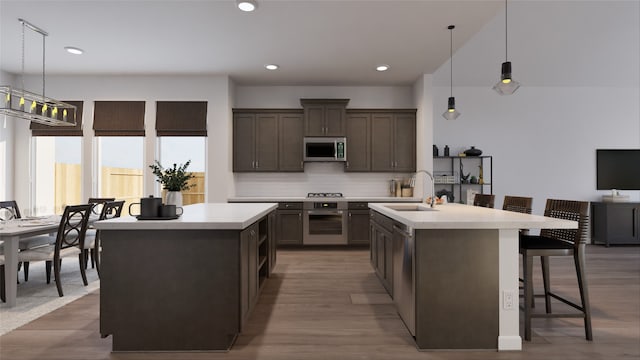 21119 Flowerhorn Dr, Cypress, TX 77433 - kitchen with stainless steel appliances, a kitchen island with sink, a sink, light countertops, and recessed lighting