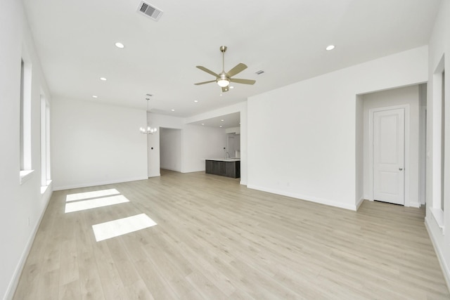 21122 Flowerhorn Dr, Cypress, TX 77433 - unfurnished living room featuring a chandelier, a ceiling fan, light wood-type flooring, recessed lighting, and baseboards