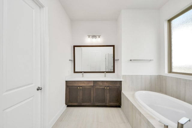 21122 Flowerhorn Dr, Cypress, TX 77433 - bathroom featuring double vanity, a bath, and plenty of natural light