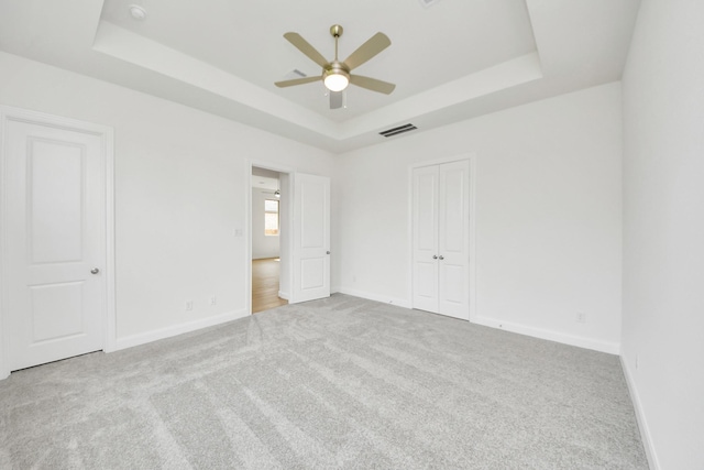 21122 Flowerhorn Dr, Cypress, TX 77433 - unfurnished bedroom with a tray ceiling, carpet, baseboards, and a ceiling fan