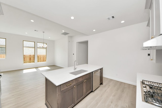 21122 Flowerhorn Dr, Cypress, TX 77433 - kitchen with a sink, appliances with stainless steel finishes, a chandelier, light wood-style flooring, and light countertops