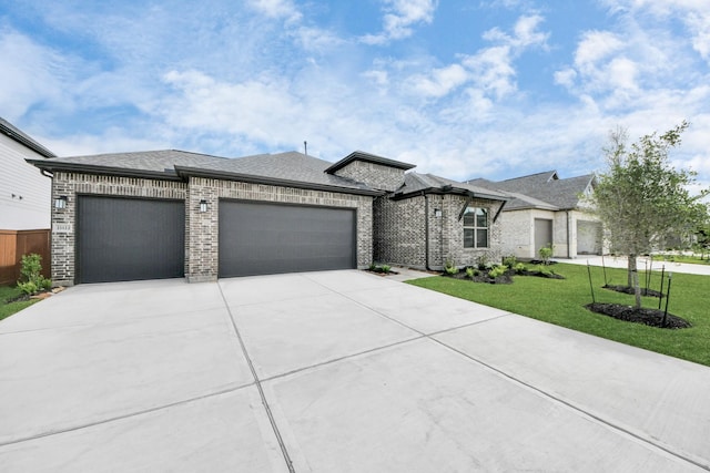 21122 Flowerhorn Dr, Cypress, TX 77433 - view of front of property featuring a garage, driveway, a front lawn, brick siding, and roof with shingles