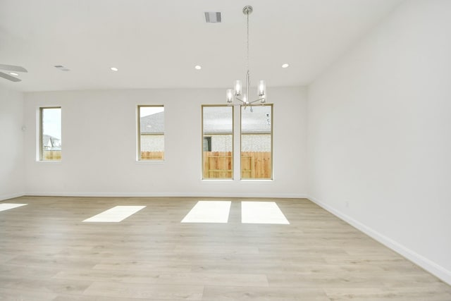 21122 Flowerhorn Dr, Cypress, TX 77433 - spare room featuring healthy amount of natural light, a chandelier, light wood-style flooring, baseboards, and recessed lighting