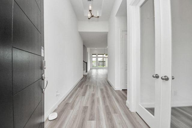 21114 Regal Terrace Dr, Cypress, TX 77433 - corridor with a chandelier, light wood finished floors, and baseboards