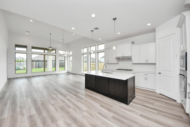 21114 Regal Terrace Dr, Cypress, TX 77433 - kitchen featuring a sink, appliances with stainless steel finishes, recessed lighting, light countertops, and white cabinetry