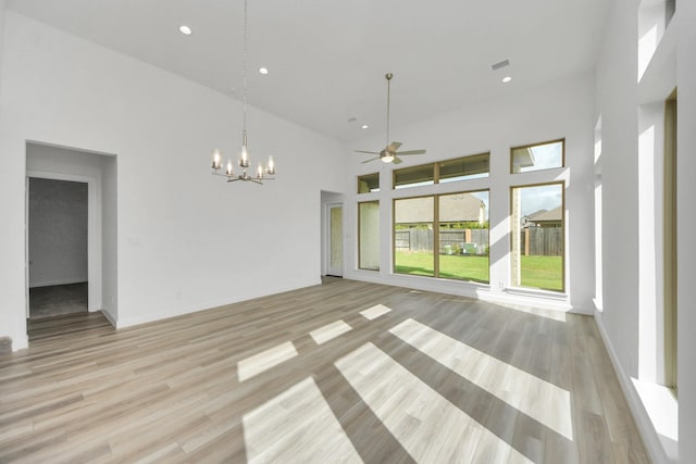 21114 Regal Terrace Dr, Cypress, TX 77433 - empty room featuring a high ceiling, a chandelier, ceiling fan, light wood-style flooring, and recessed lighting