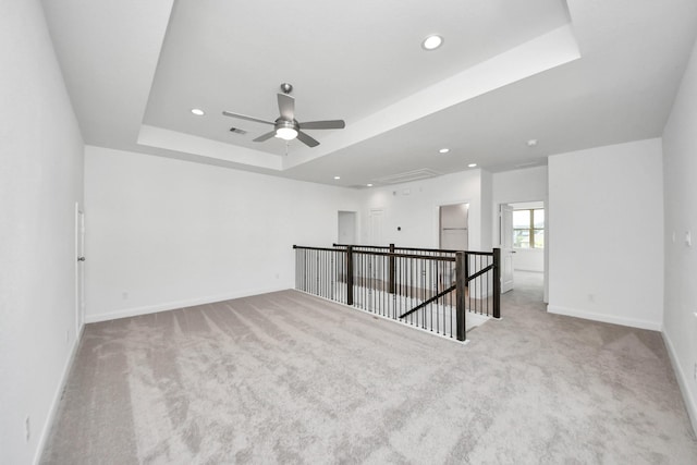 21114 Regal Terrace Dr, Cypress, TX 77433 - carpeted empty room featuring a tray ceiling, baseboards, attic access, recessed lighting, and ceiling fan