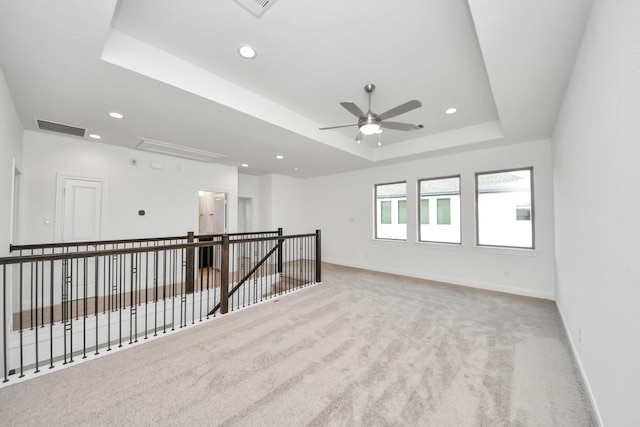 21114 Regal Terrace Dr, Cypress, TX 77433 - empty room featuring attic access, carpet flooring, a raised ceiling, baseboards, and a ceiling fan