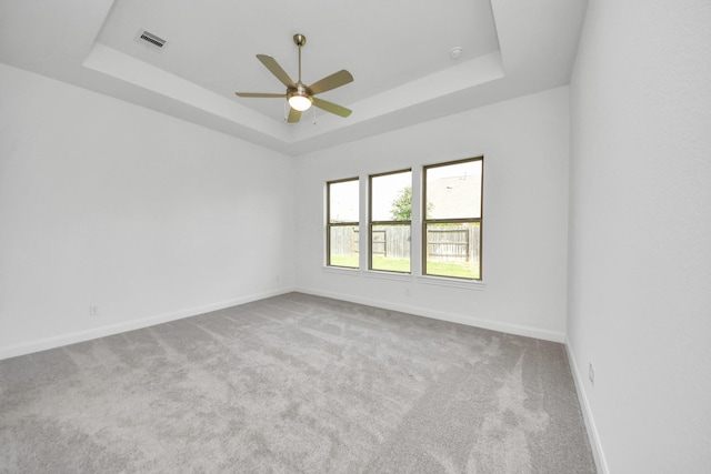 21114 Regal Terrace Dr, Cypress, TX 77433 - unfurnished room featuring a tray ceiling, carpet floors, baseboards, and a ceiling fan