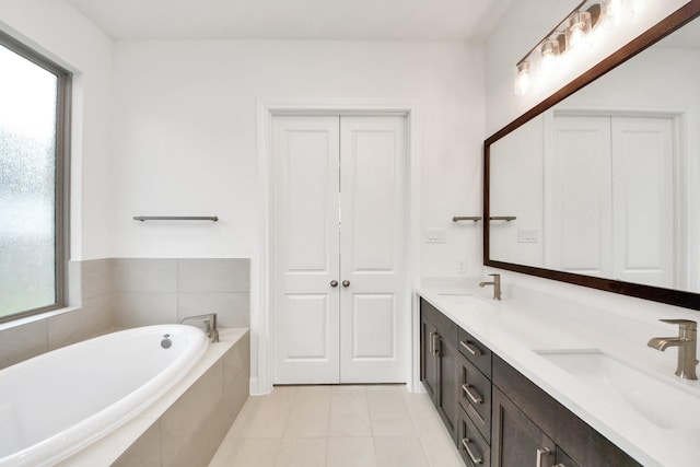 21130 Flowerhorn Dr, Cypress, TX 77433 - bathroom with healthy amount of natural light, double vanity, a garden tub, and tile patterned floors