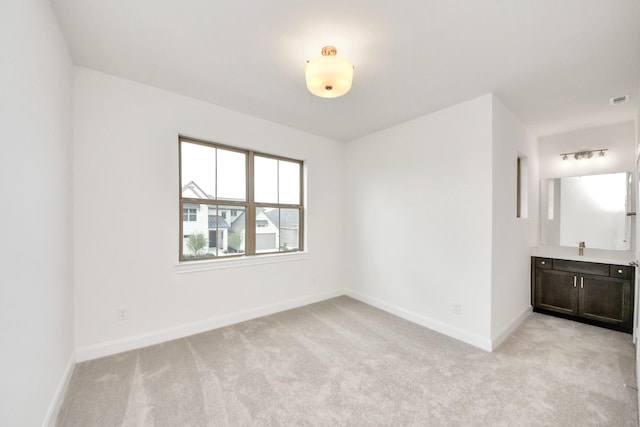 21130 Flowerhorn Dr, Cypress, TX 77433 - empty room featuring light carpet, baseboards, and a sink