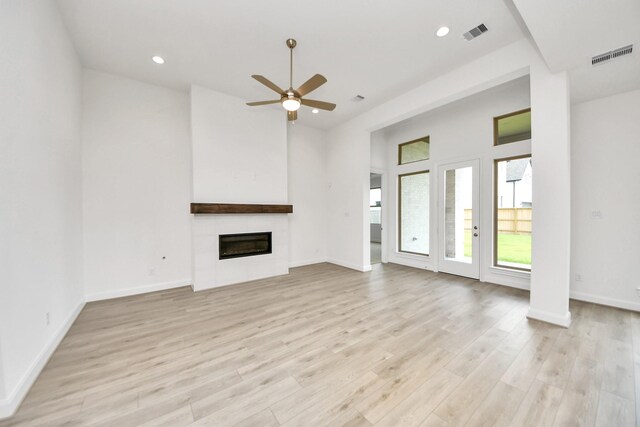 21130 Flowerhorn Dr, Cypress, TX 77433 - unfurnished living room featuring ceiling fan, recessed lighting, light wood finished floors, a large fireplace, and baseboards