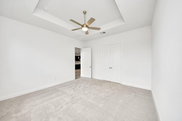 21130 Flowerhorn Dr, Cypress, TX 77433 - unfurnished bedroom featuring a raised ceiling, carpet flooring, baseboards, and a closet