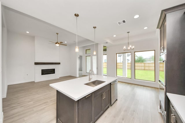 21130 Flowerhorn Dr, Cypress, TX 77433 - kitchen with a sink, dishwasher, light wood-style floors, light countertops, and recessed lighting