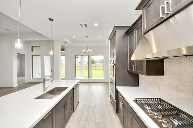 21130 Flowerhorn Dr, Cypress, TX 77433 - kitchen featuring under cabinet range hood, appliances with stainless steel finishes, light wood finished floors, light countertops, and recessed lighting