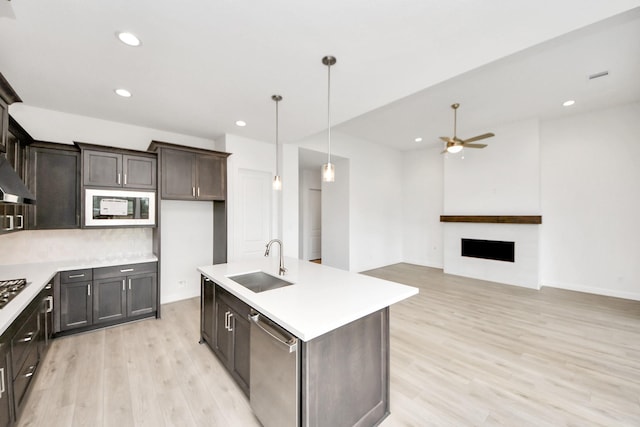 21130 Flowerhorn Dr, Cypress, TX 77433 - kitchen featuring a sink, dishwasher, built in microwave, light wood-type flooring, and a ceiling fan
