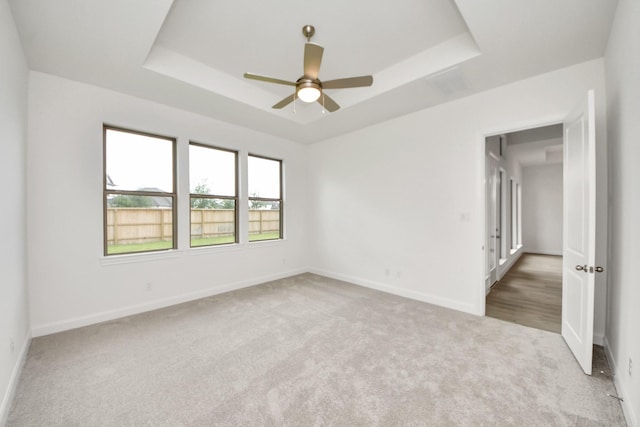 21130 Flowerhorn Dr, Cypress, TX 77433 - unfurnished room featuring a raised ceiling, carpet floors, baseboards, and ceiling fan