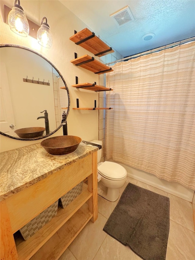 798 Port Blvd, Trinity, TX 75862 - bathroom with toilet, vanity, tile patterned flooring, and shower / bath combo with shower curtain