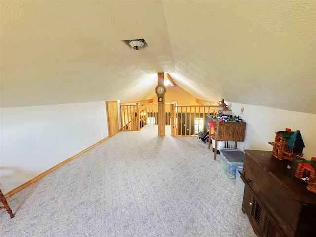 798 Port Blvd, Trinity, TX 75862 - additional living space featuring carpet floors, a textured ceiling, and vaulted ceiling