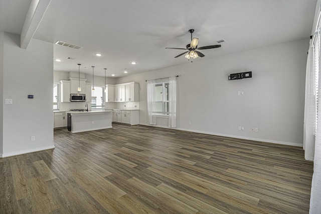 1930 Pueblo Nuevo Path, Houston, TX 77077 - unfurnished living room featuring ceiling fan, dark wood-style floors, recessed lighting, and baseboards