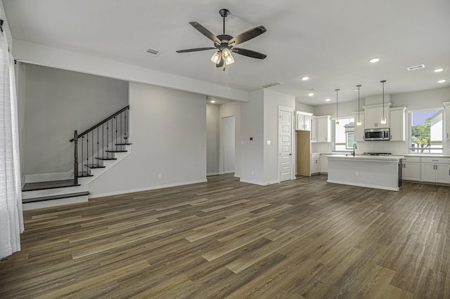 1930 Pueblo Nuevo Path, Houston, TX 77077 - unfurnished living room featuring dark wood-style floors, a ceiling fan, recessed lighting, stairway, and baseboards