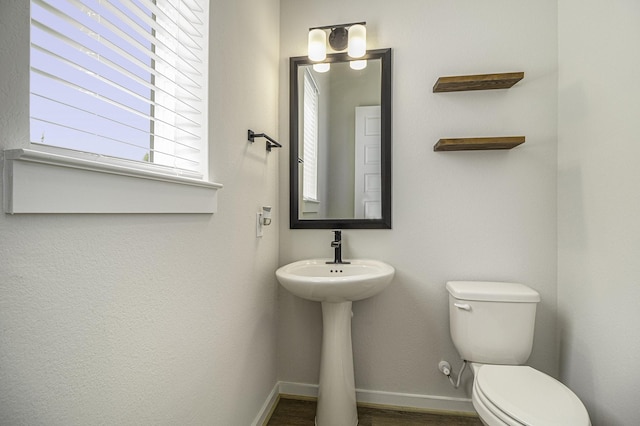 1930 Pueblo Nuevo Path, Houston, TX 77077 - half bathroom featuring toilet, baseboards, wood finished floors, and a sink