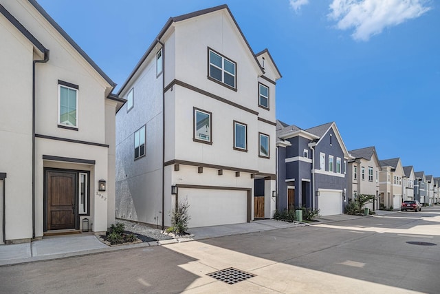 1930 Pueblo Nuevo Path, Houston, TX 77077 - view of front facade featuring a residential view, driveway, a garage, and stucco siding