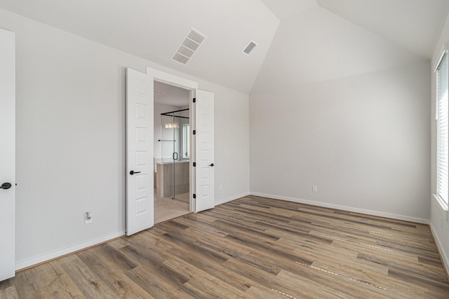 1930 Pueblo Nuevo Path, Houston, TX 77077 - unfurnished bedroom with wood finished floors, baseboards, high vaulted ceiling, and ensuite bath