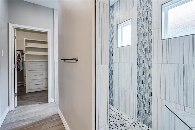 8105 Denali Dr, Corpus Christi, TX 78414 - full bathroom featuring a walk in shower, a walk in closet, wood finished floors, and baseboards