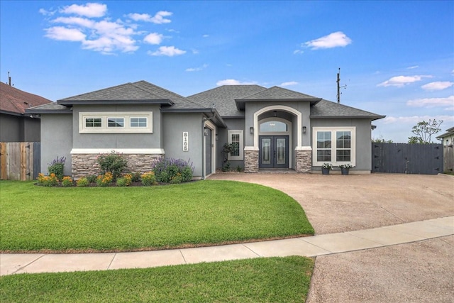 8105 Denali Dr, Corpus Christi, TX 78414 - prairie-style house with stucco siding, french doors, stone siding, roof with shingles, and concrete driveway