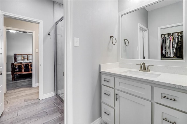 8105 Denali Dr, Corpus Christi, TX 78414 - bathroom with vanity, a spacious closet, wood finished floors, and baseboards