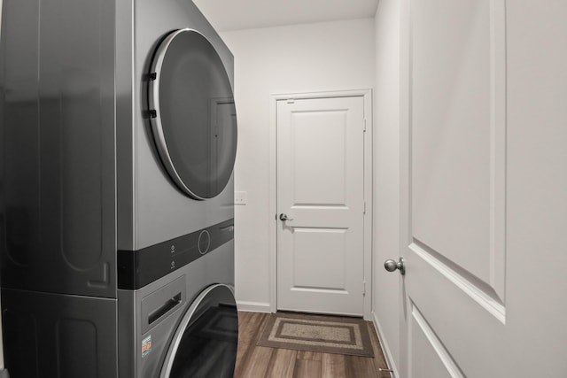 3511 Queensberry Ct, Huffman, TX 77336 - laundry area featuring stacked washer and clothes dryer, dark wood finished floors, and baseboards
