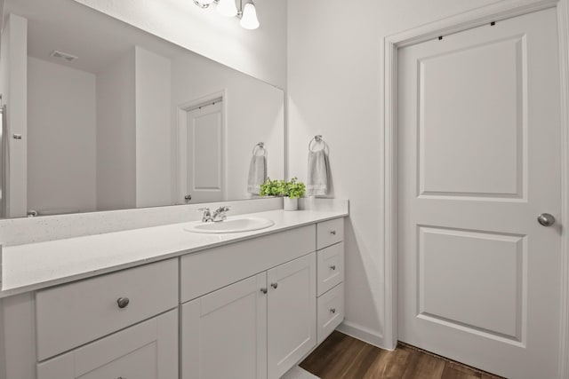 3511 Queensberry Ct, Huffman, TX 77336 - bathroom with vanity, wood finished floors, and baseboards