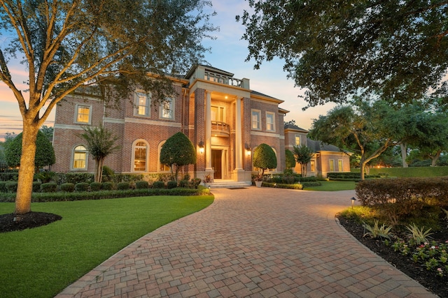16 Grand Mnr, Sugar Land, TX 77479 - view of front of home with curved driveway, a yard, and brick siding