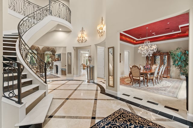16 Grand Mnr, Sugar Land, TX 77479 - foyer with a chandelier, stairway, baseboards, a towering ceiling, and a tray ceiling