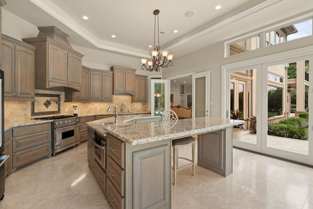 16 Grand Mnr, Sugar Land, TX 77479 - kitchen with stainless steel appliances, a sink, backsplash, french doors, and a center island with sink