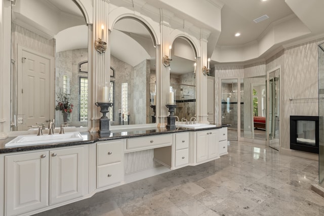16 Grand Mnr, Sugar Land, TX 77479 - full bathroom featuring double vanity, ornamental molding, a tile shower, and a high end fireplace