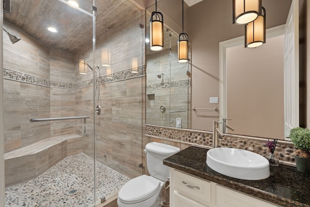16 Grand Mnr, Sugar Land, TX 77479 - full bathroom featuring vanity, a stall shower, toilet, and tasteful backsplash