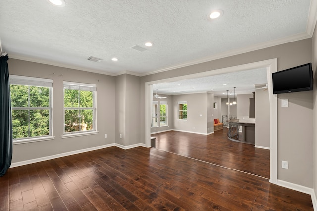 16 Grand Mnr, Sugar Land, TX 77479 - unfurnished living room with a textured ceiling, ornamental molding, hardwood / wood-style floors, baseboards, and a chandelier
