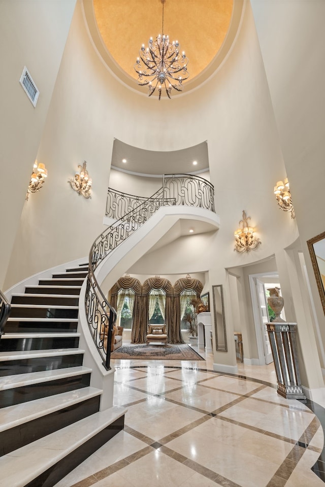 16 Grand Mnr, Sugar Land, TX 77479 - foyer entrance with inlaid floor details, a high ceiling, a chandelier, plenty of natural light, and baseboards
