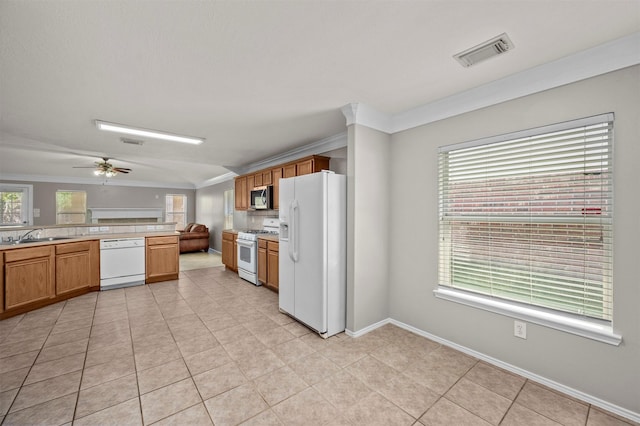 8014 Blackcherry Ln, Baytown, TX 77523 - kitchen featuring white appliances, ornamental molding, decorative backsplash, healthy amount of natural light, and light countertops