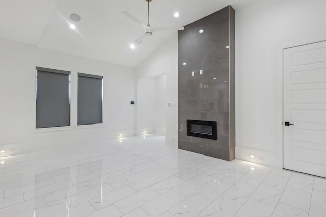 3505 Cobb St, Houston, TX 77004 - unfurnished living room with marble look tile flooring, lofted ceiling, a tile fireplace, and recessed lighting