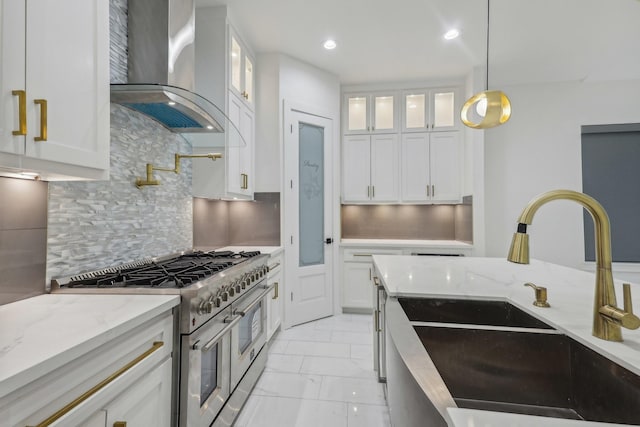 3505 Cobb St, Houston, TX 77004 - kitchen with range hood, range with two ovens, a sink, light marble finish floors, and white cabinetry