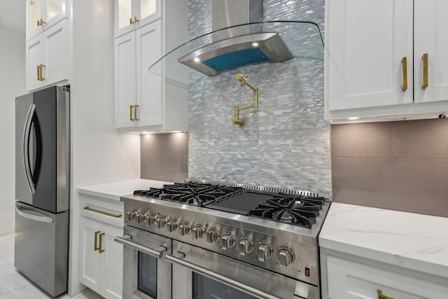 3505 Cobb St, Houston, TX 77004 - kitchen featuring stainless steel appliances, wall chimney range hood, backsplash, white cabinets, and glass insert cabinets