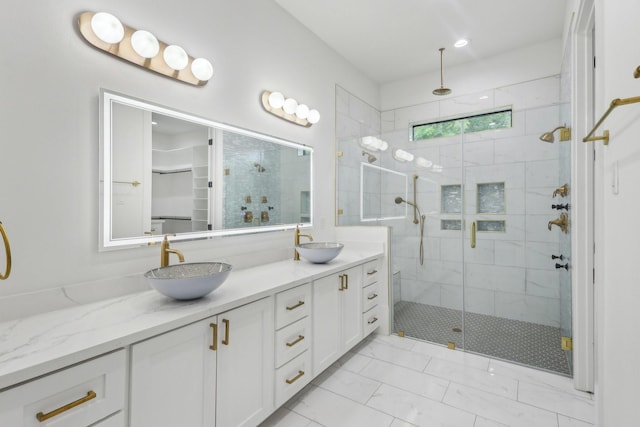 3505 Cobb St, Houston, TX 77004 - full bath featuring a stall shower, double vanity, a spacious closet, and marble look tiles
