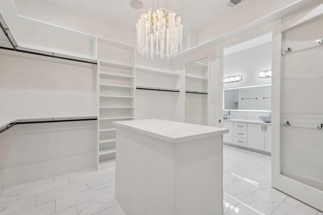 3505 Cobb St, Houston, TX 77004 - spacious closet with light marble finish flooring, a chandelier, and a sink