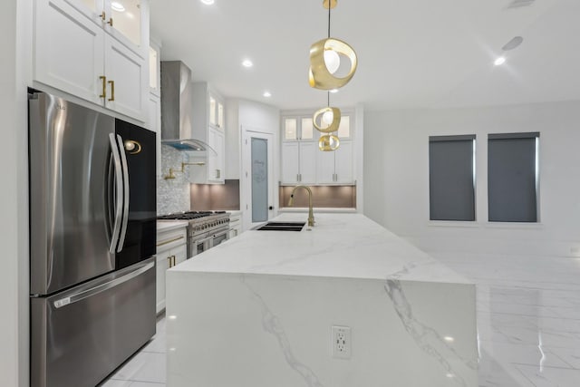 3505 Cobb St, Houston, TX 77004 - kitchen with stainless steel appliances, a sink, wall chimney range hood, white cabinetry, and backsplash