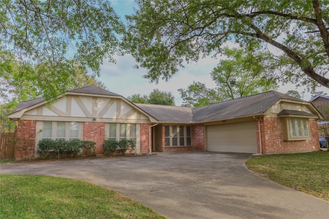 3911 Cypress Lake Dr, Spring, TX 77388 - view of front of home featuring brick siding, a garage, concrete driveway, a shingled roof, and a front lawn