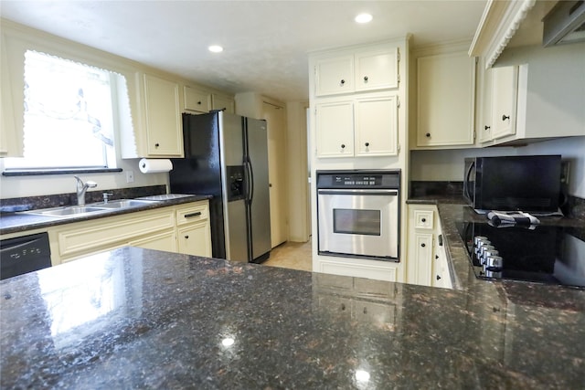3911 Cypress Lake Dr, Spring, TX 77388 - kitchen featuring black appliances, a sink, dark stone countertops, and recessed lighting