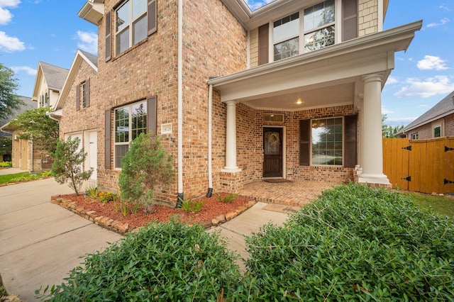4726 Ashley Hope Dr, Katy, TX 77494 - view of front facade with brick siding, a gate, driveway, covered porch, and a garage